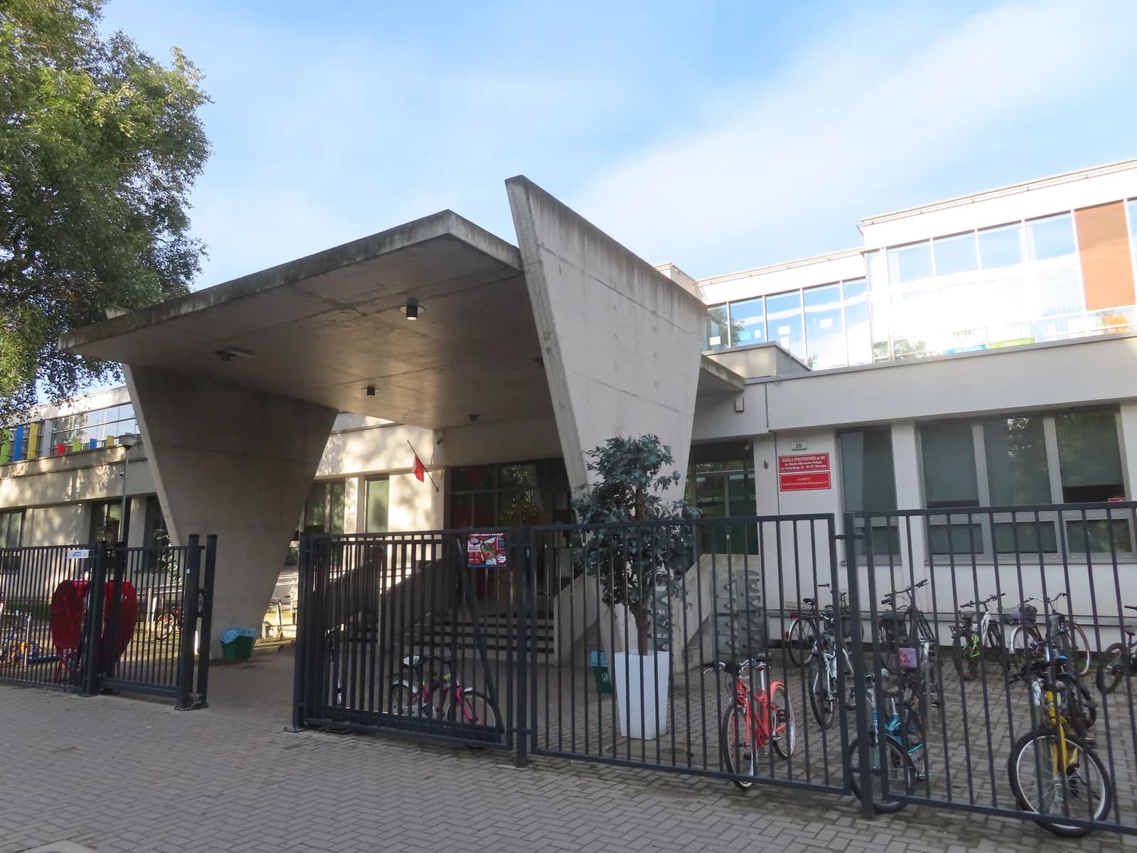 Exterior of Primary School No. 84 in Wrocław, Poland, with bikes parked.