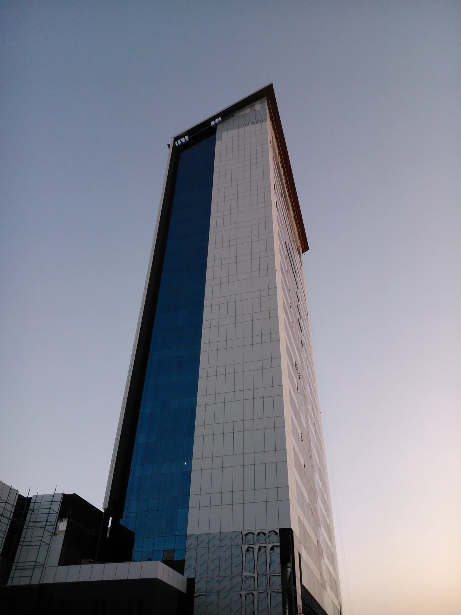 Modern skyscraper in Olaya district, Riyadh, Saudi Arabia at sunset.