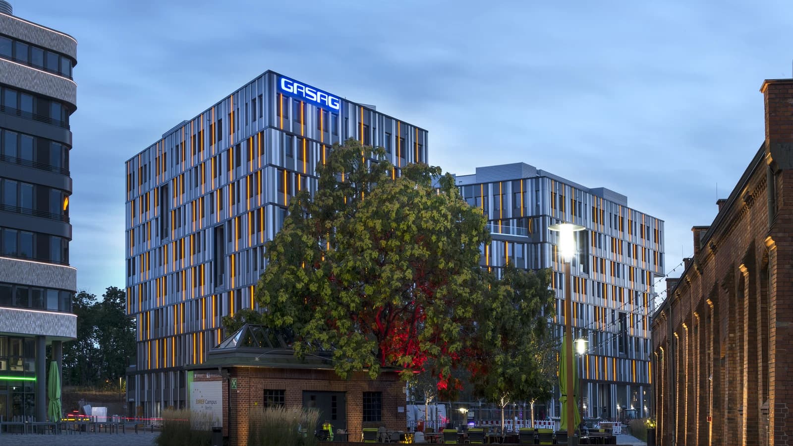 Exterior view of the modern GASAG office building with illuminated windows at dusk.