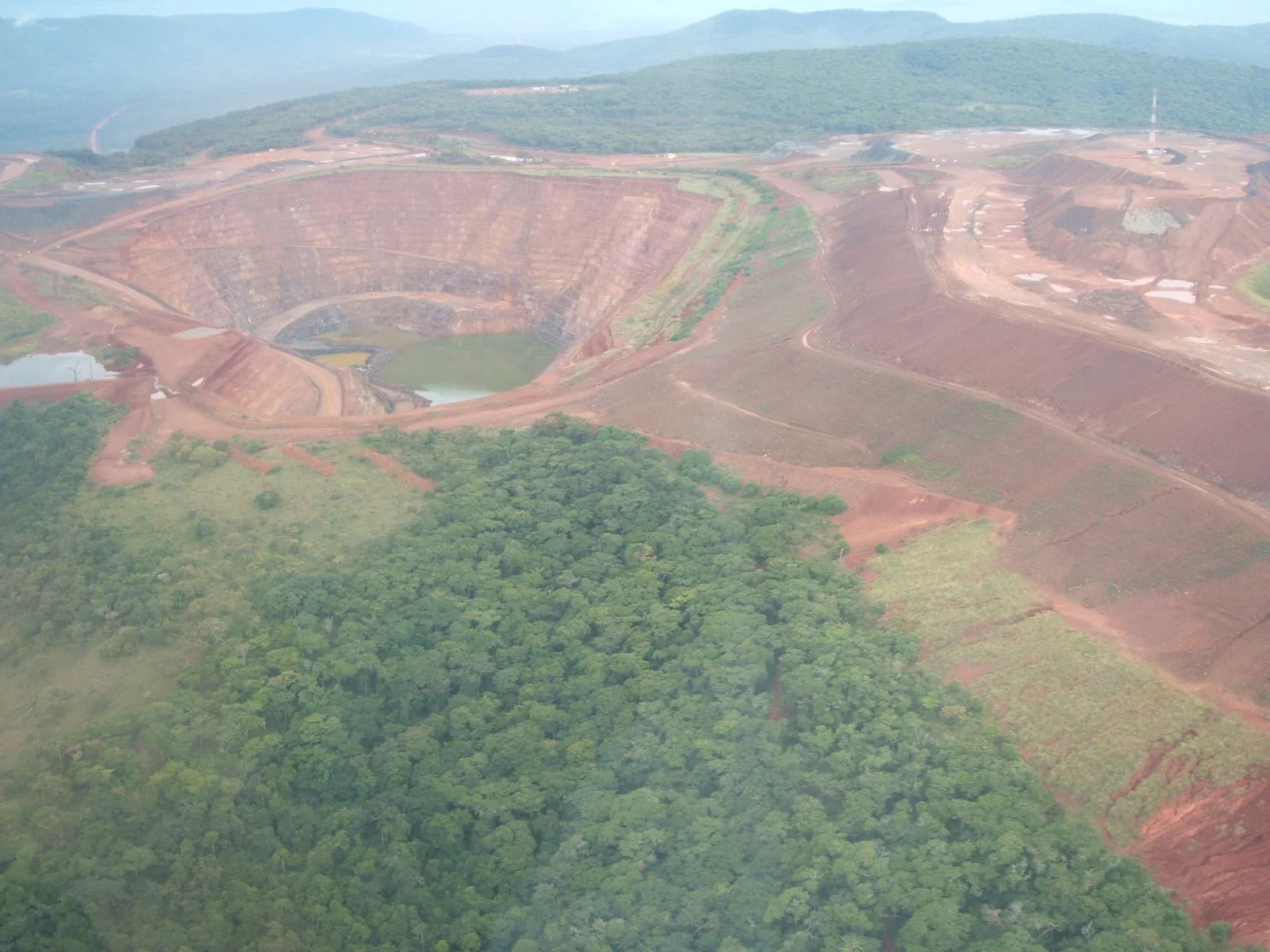 Aerial view of the massive Geita open pit gold mine with surrounding landscape.