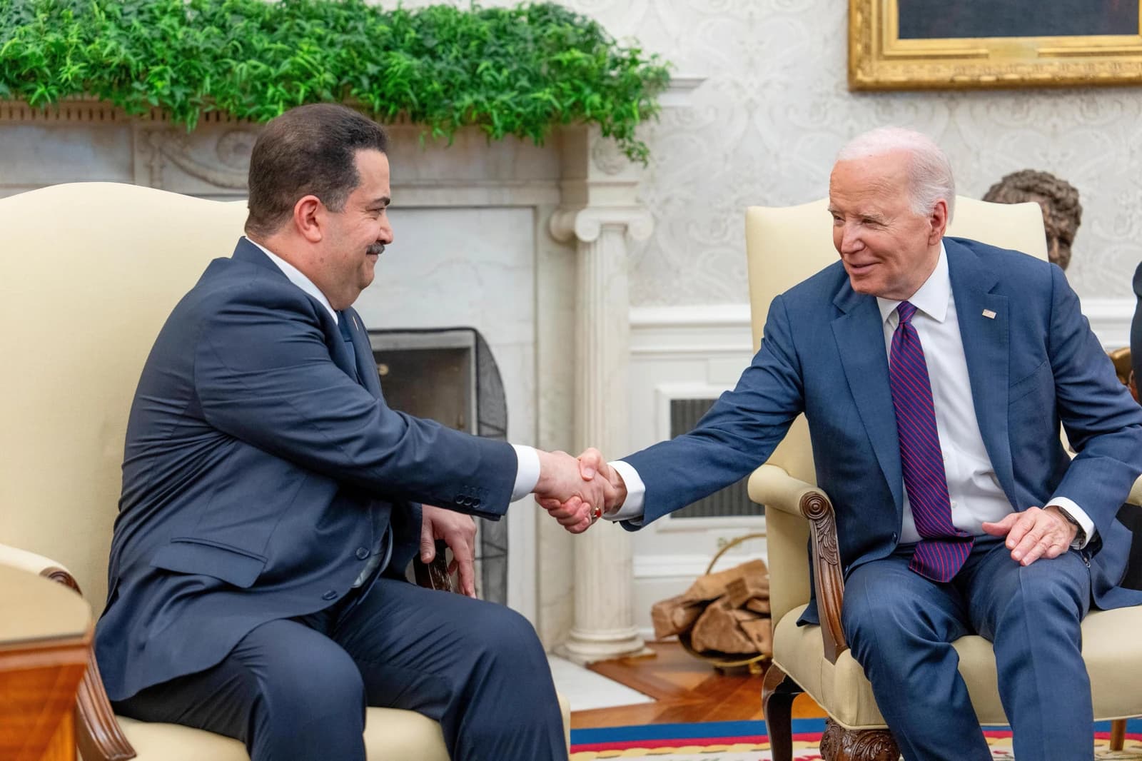 President Joe Biden shakes hands with Prime Minister Mohammed Shia' Al Sudani in the Oval Office.