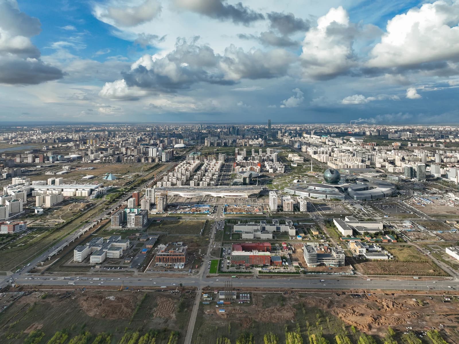 Aerial view showing modern city buildings and the EXPO-2017 sphere in Astana, Kazakhstan.