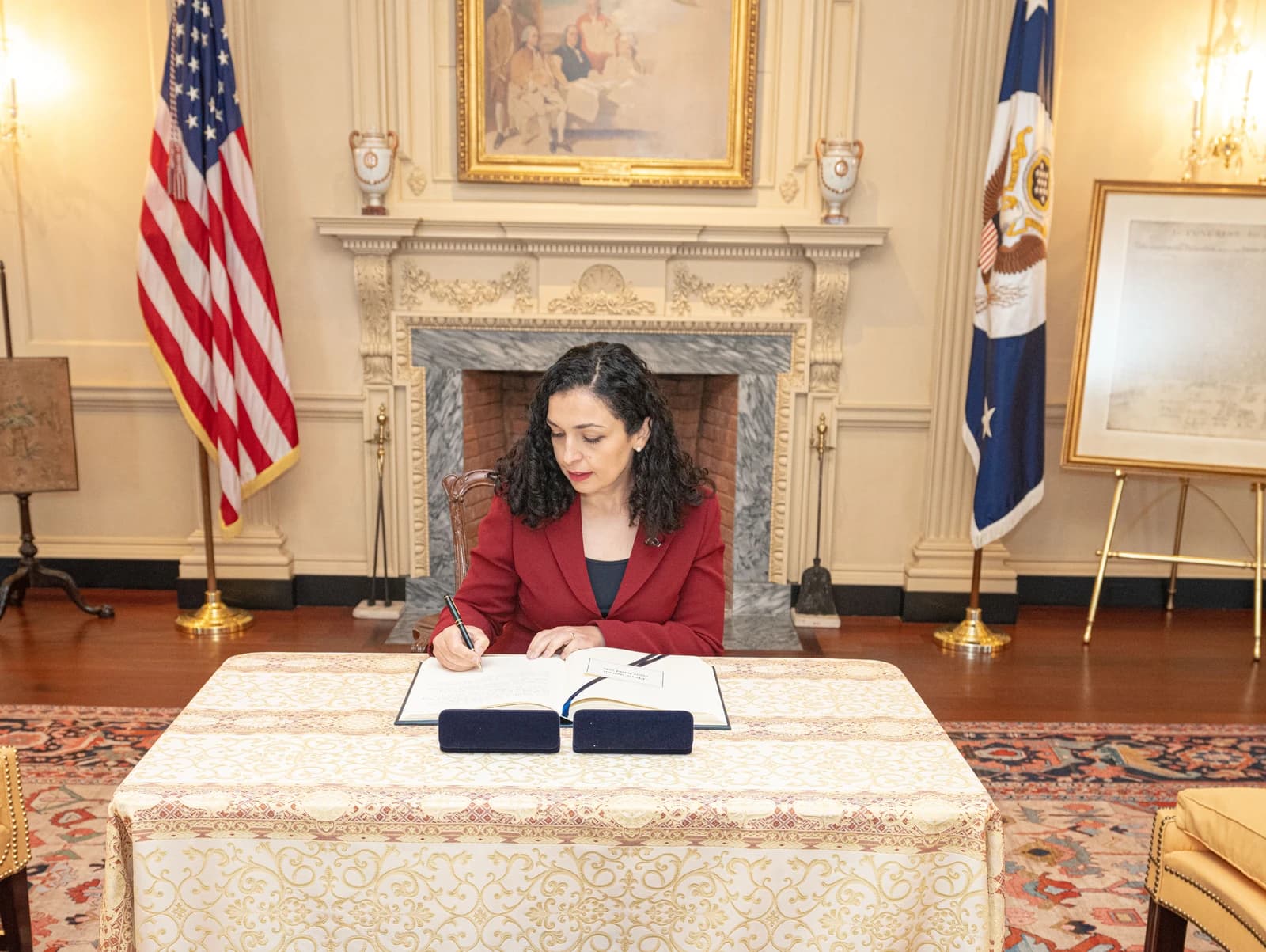 Vjosa Osmani, President of Kosovo, writing in a guest book.