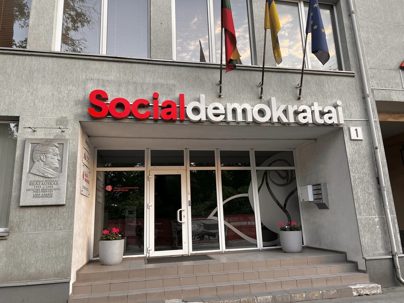 Building entrance with "Socialdemokratai" sign, Lithuanian, European Union flags above.