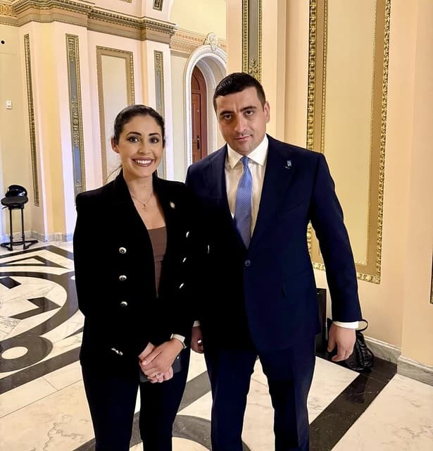 George Simion, Romanian far-right politician, and Anna Paulina Luna, U.S. Congresswoman, standing and smiling.