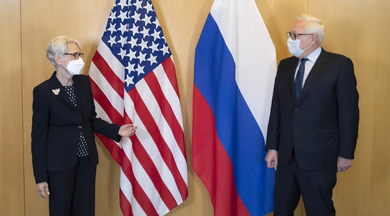 Deputy Secretary of State Wendy Sherman and Russian Deputy Foreign Minister Sergey Ryabkov stand by US and Russian flags.