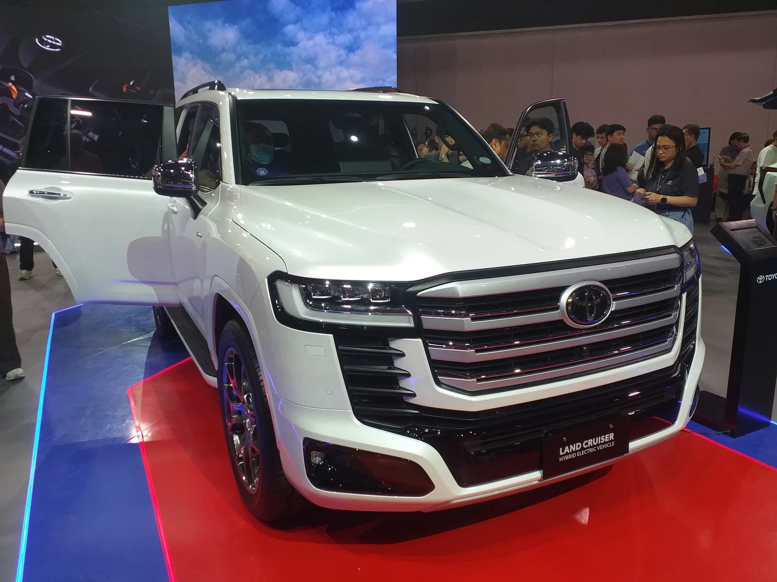 White Toyota Land Cruiser 300 VXR HEV Hybrid on display at an event.