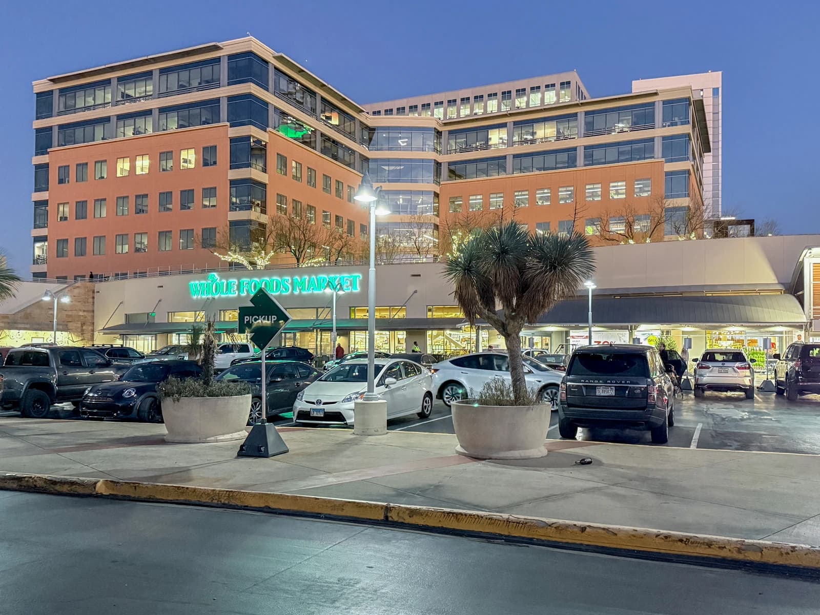 Whole Foods Market Headquarters building in Austin, Texas, with a parking lot in front.