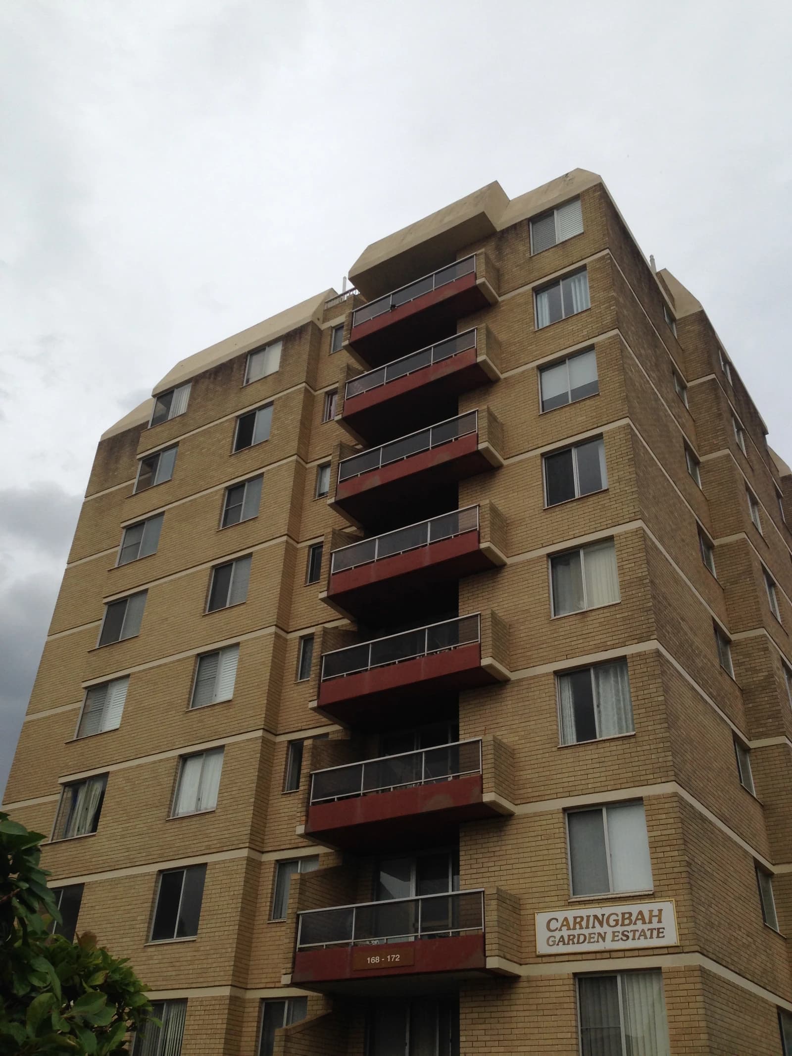 Caringbah Garden Estate apartment building in Caringbah, Australia, under a gray sky.