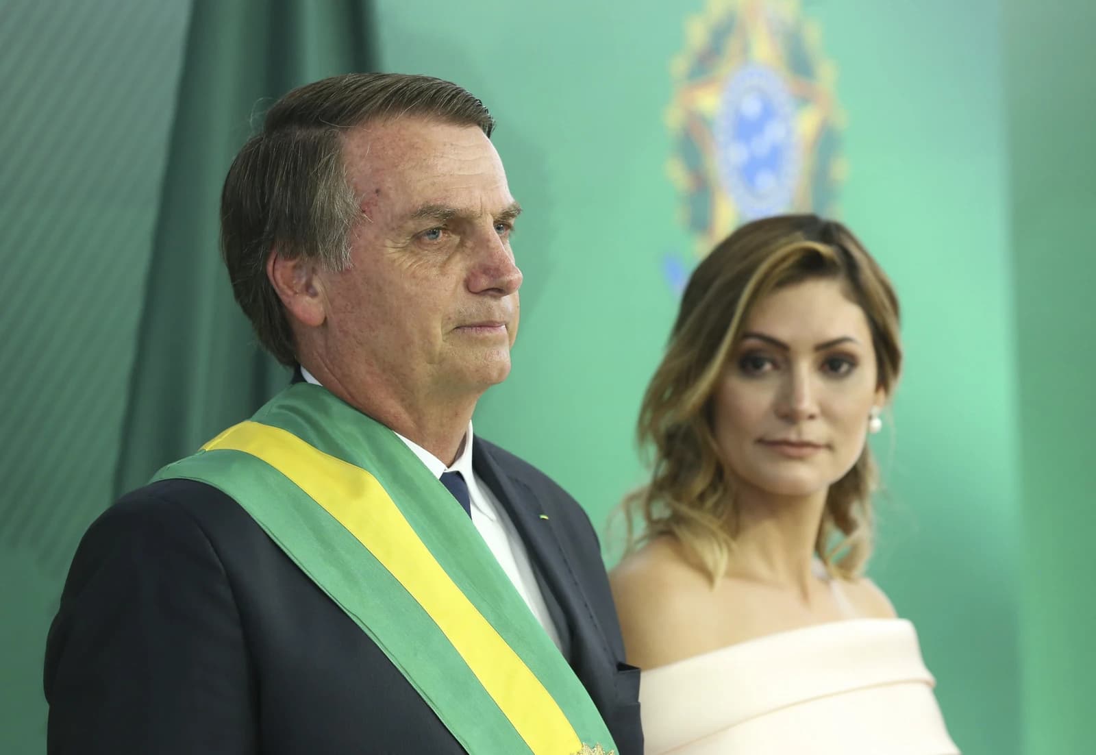 Jair Bolsonaro, President of Brazil, wears a presidential sash at an official event.