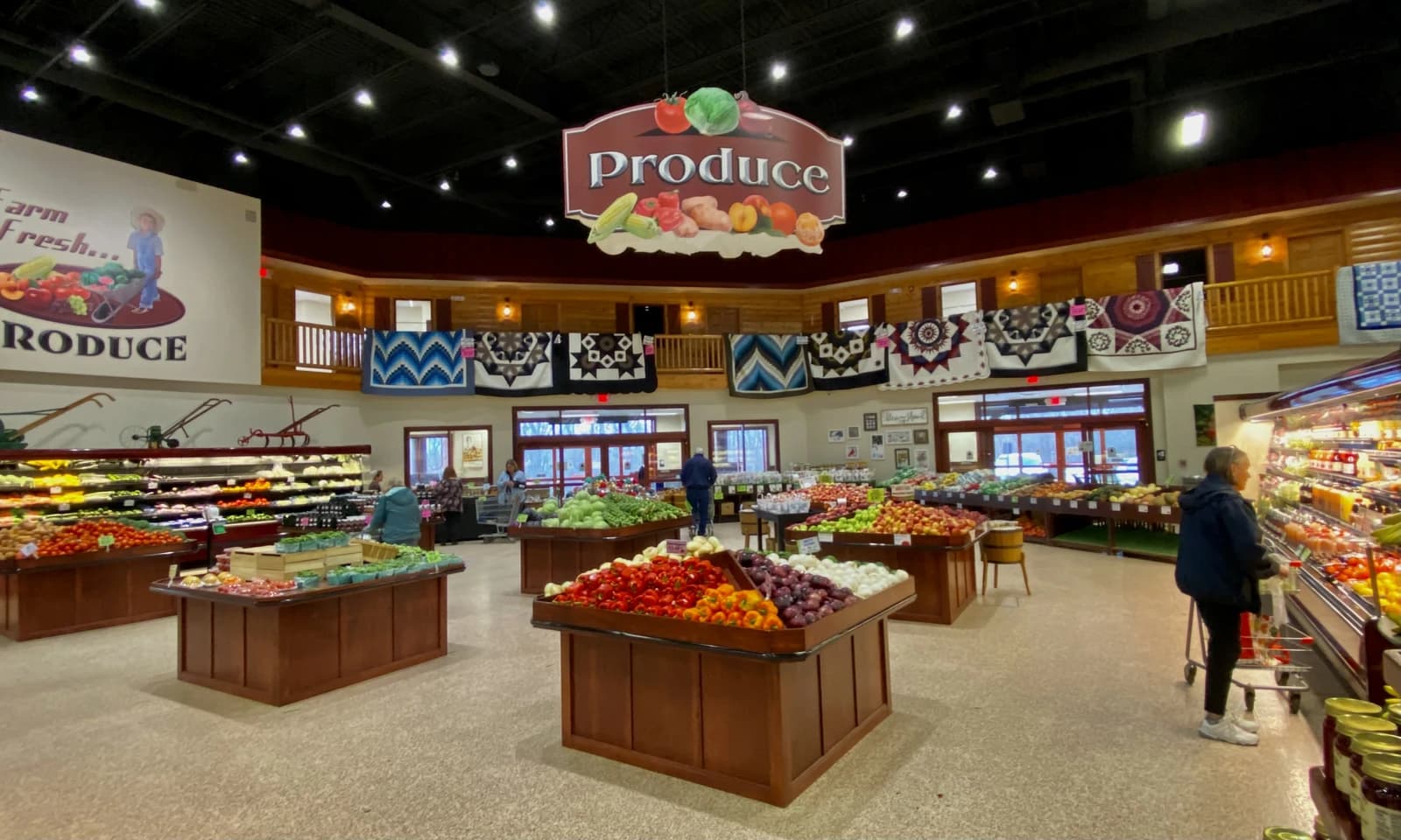 Produce department at Sauders Store with displays of fresh fruits and vegetables.
