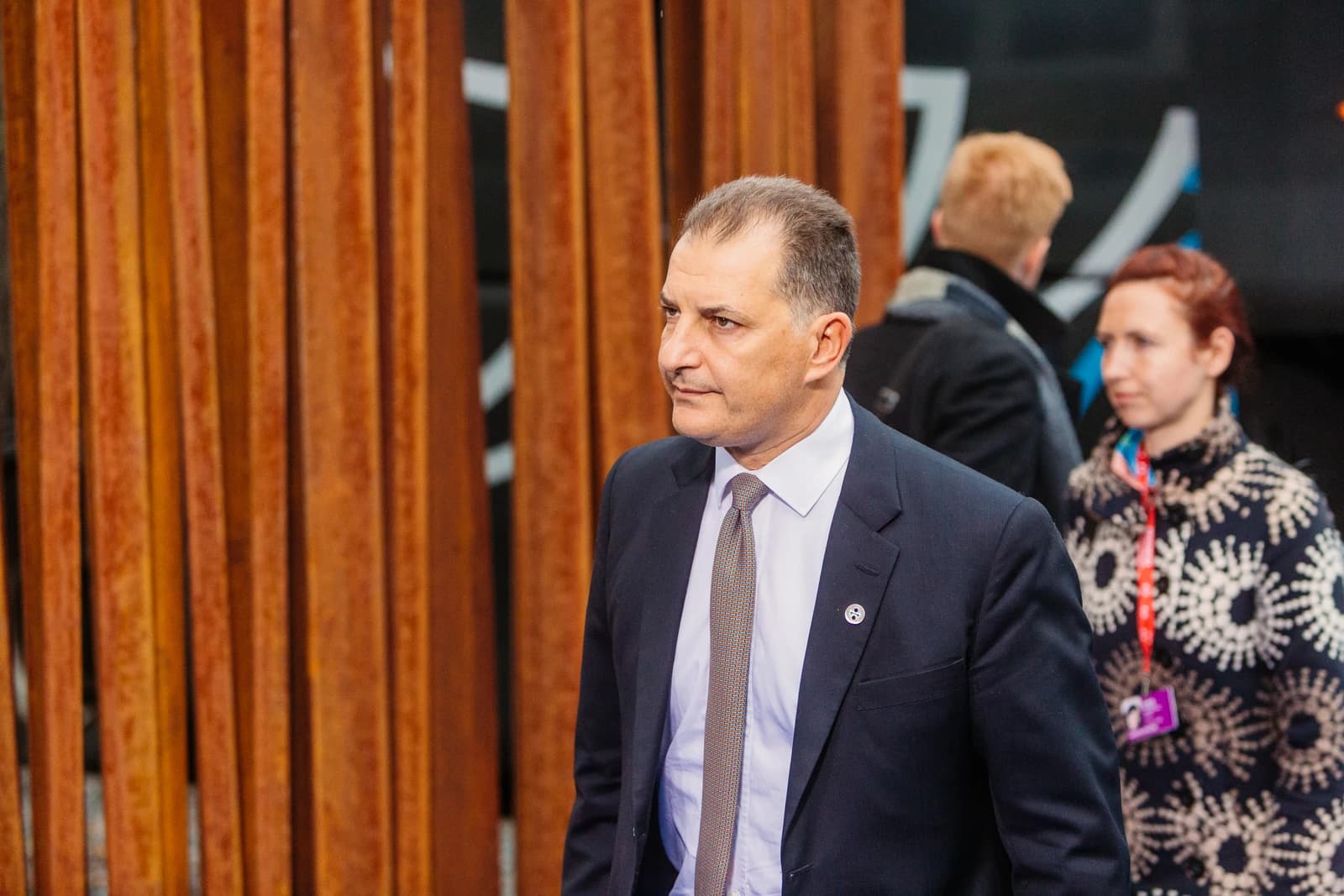 Georgios Lakkotrypis, Energy Minister, walking at a meeting.