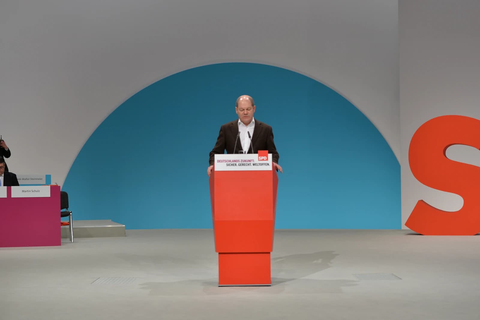 Olaf Scholz, German politician, speaking at a podium during a party event.