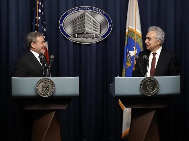 Dan Brouillette and Fatih Birol at a press conference speaking from podiums.