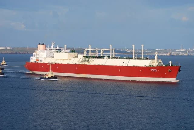 The LNG tanker Lijmiliya, owned by QatarGas, sails with assistance from tugboats.