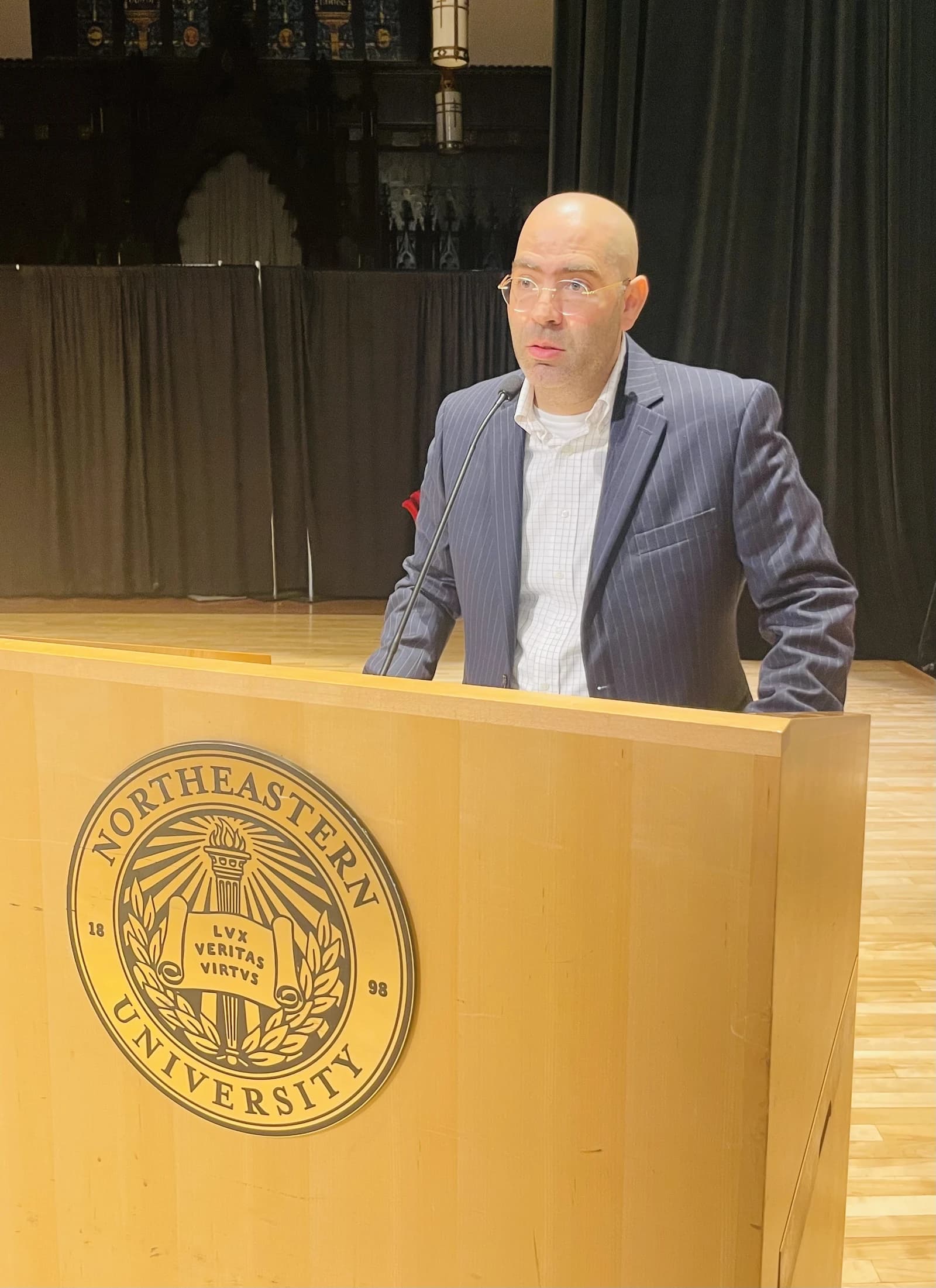 Saeed Amal, Assistant Research Professor at Northeastern University, speaks at a podium.