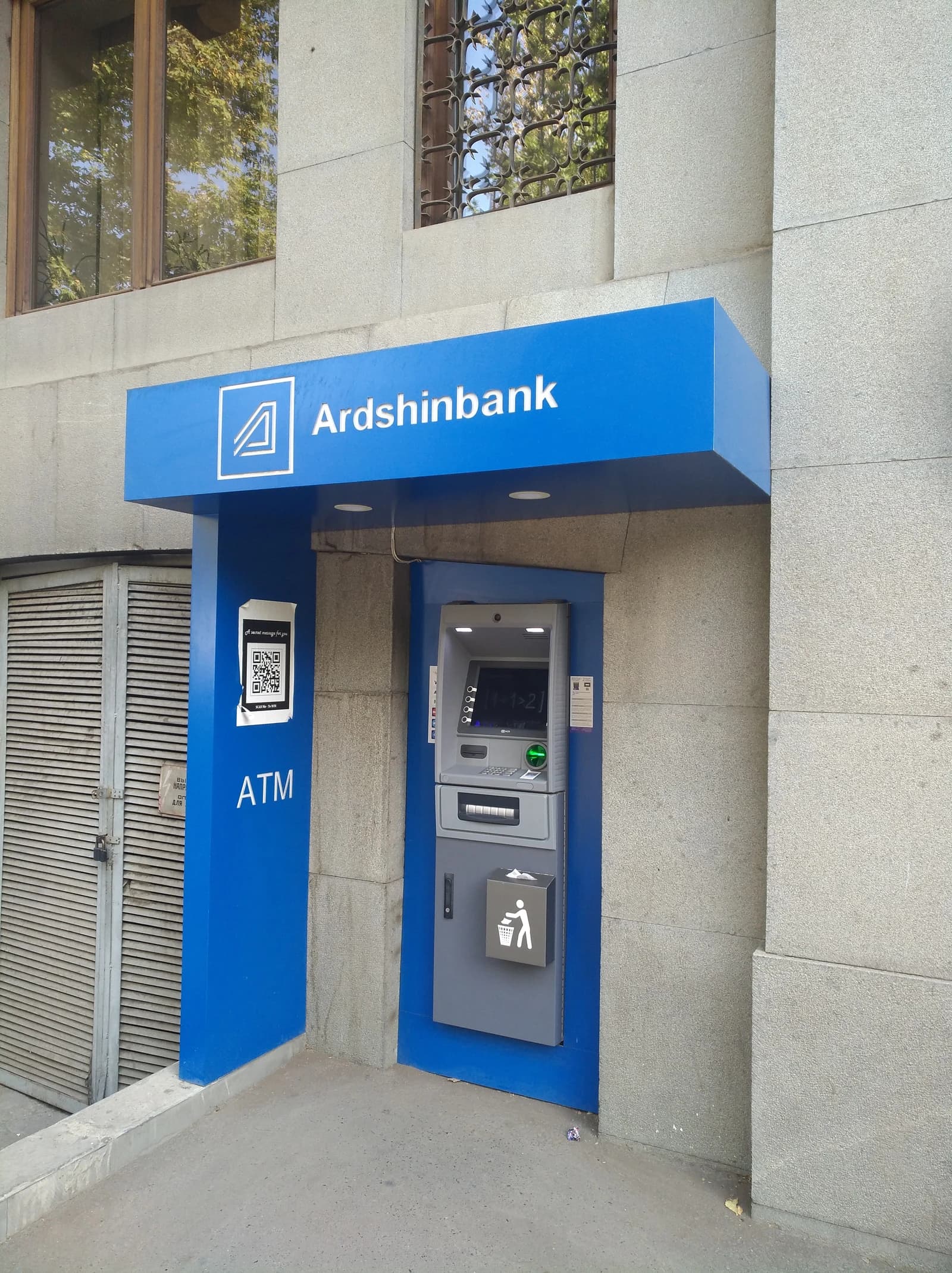 An Ardshinbank ATM with a blue canopy and a QR code sign displayed.