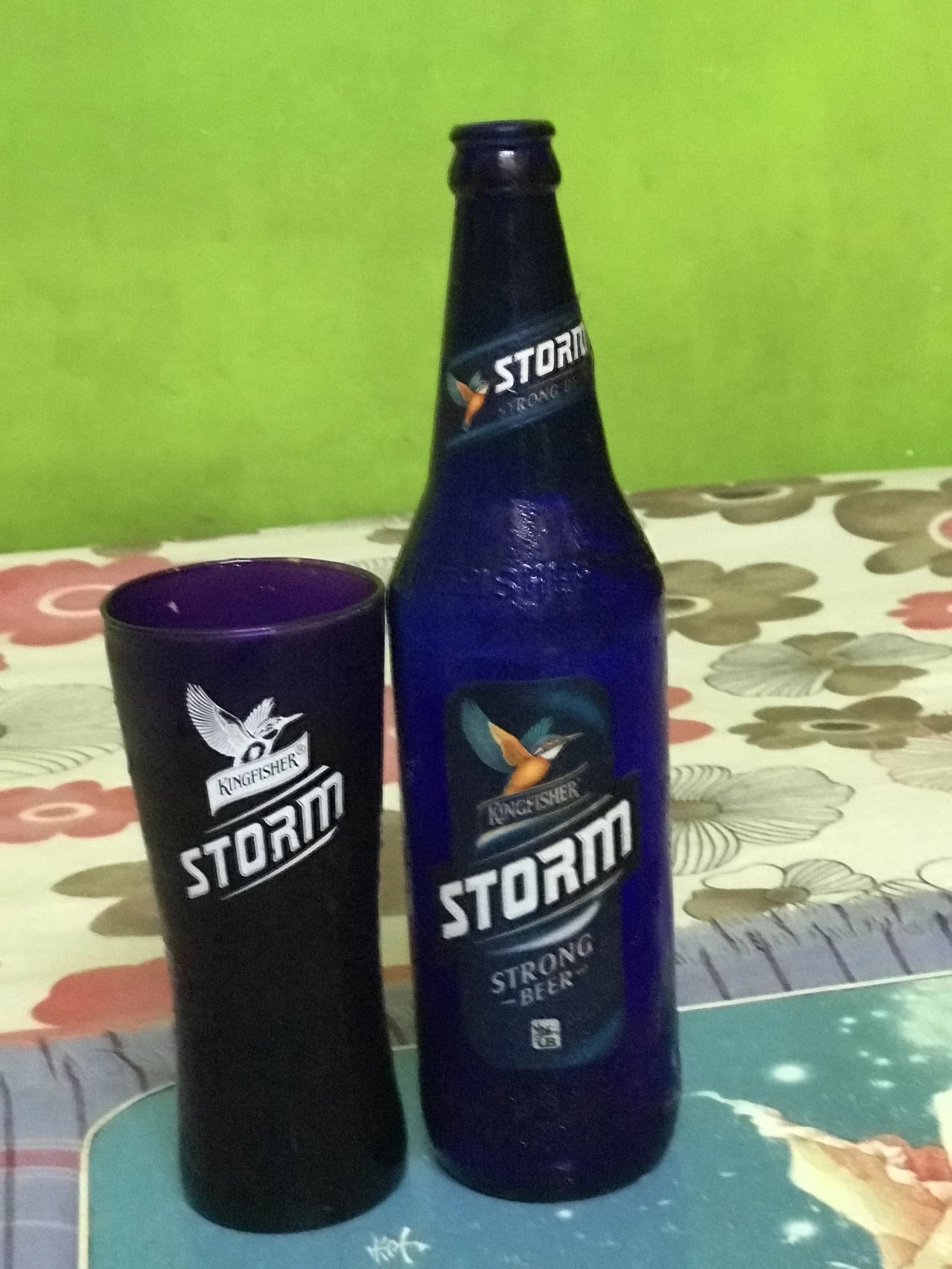Kingfisher Storm Strong Beer bottle and matching glass on a patterned tablecloth.