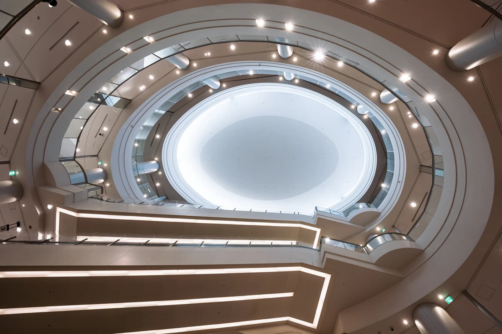 Looking up at the bright, circular atrium and ceiling of AEON Mall.