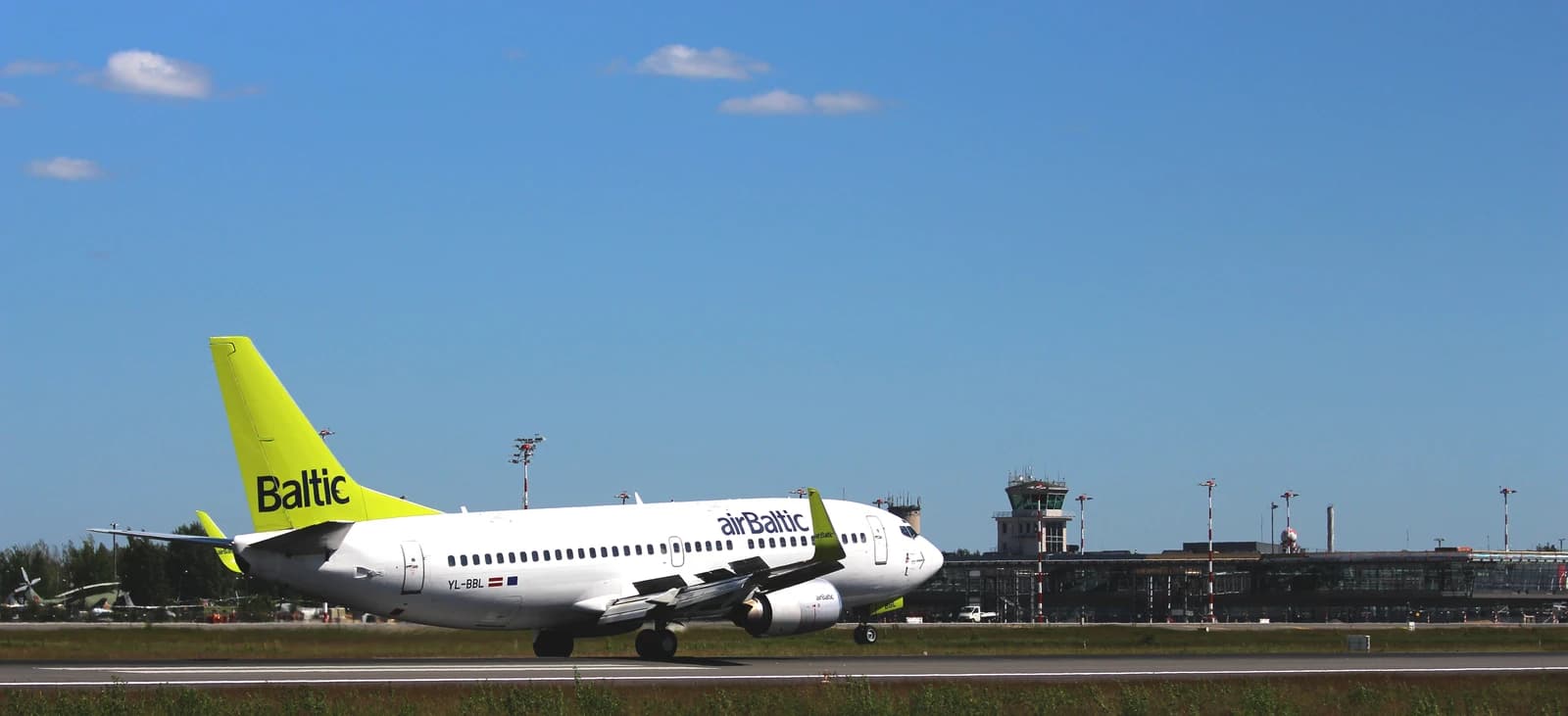 An airBaltic passenger jet on the tarmac at Riga International Airport.