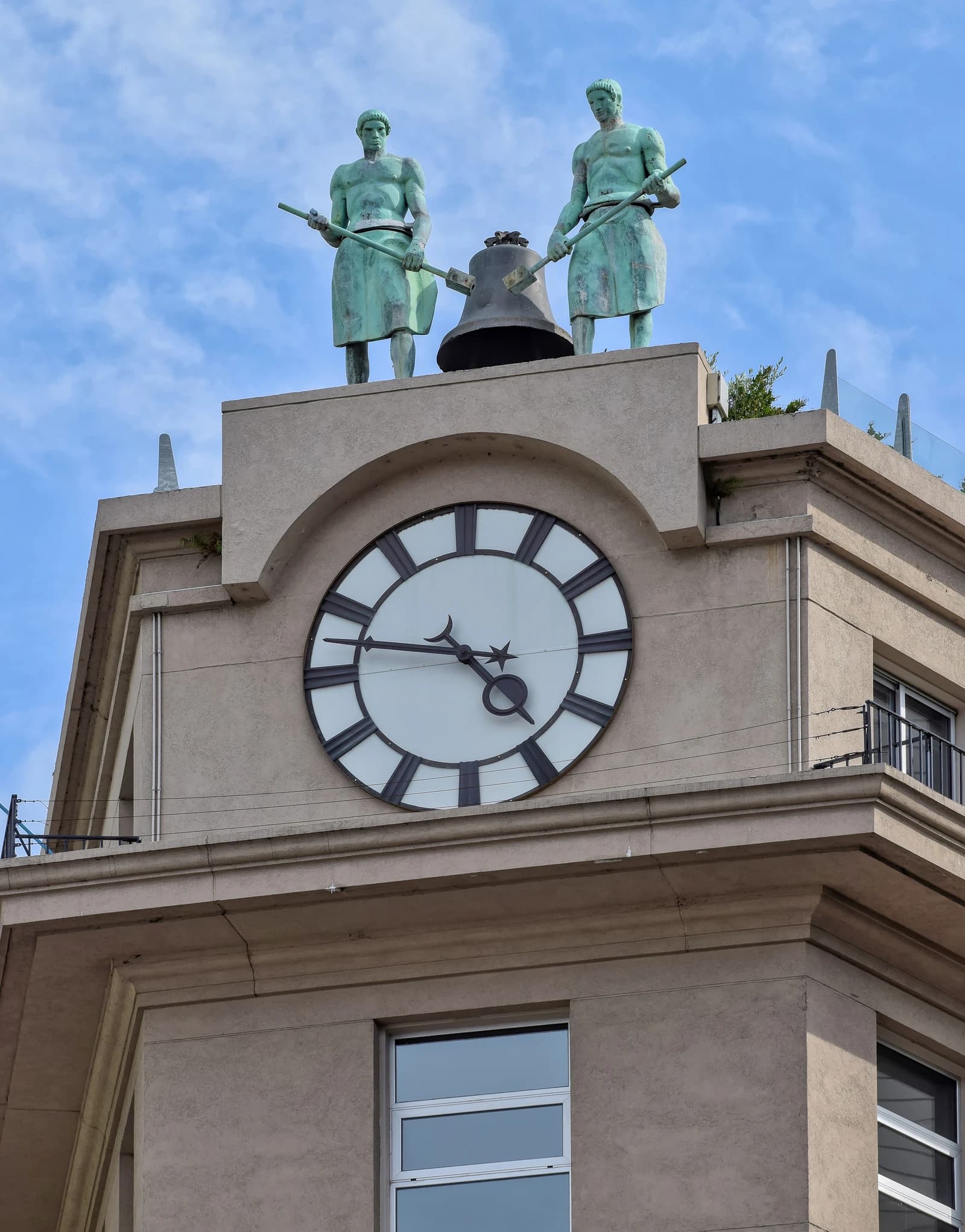 Clock and two statues on the roof of the Buenos Aires City Council building.