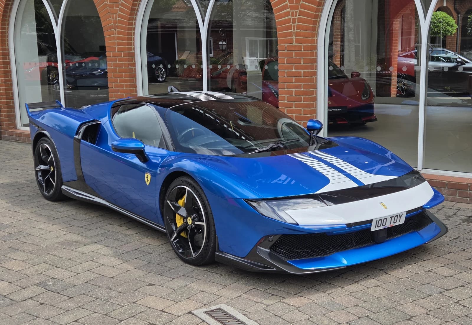 Blue Ferrari 849 Testarossa Assetto Fiorano supercar with white racing stripes.