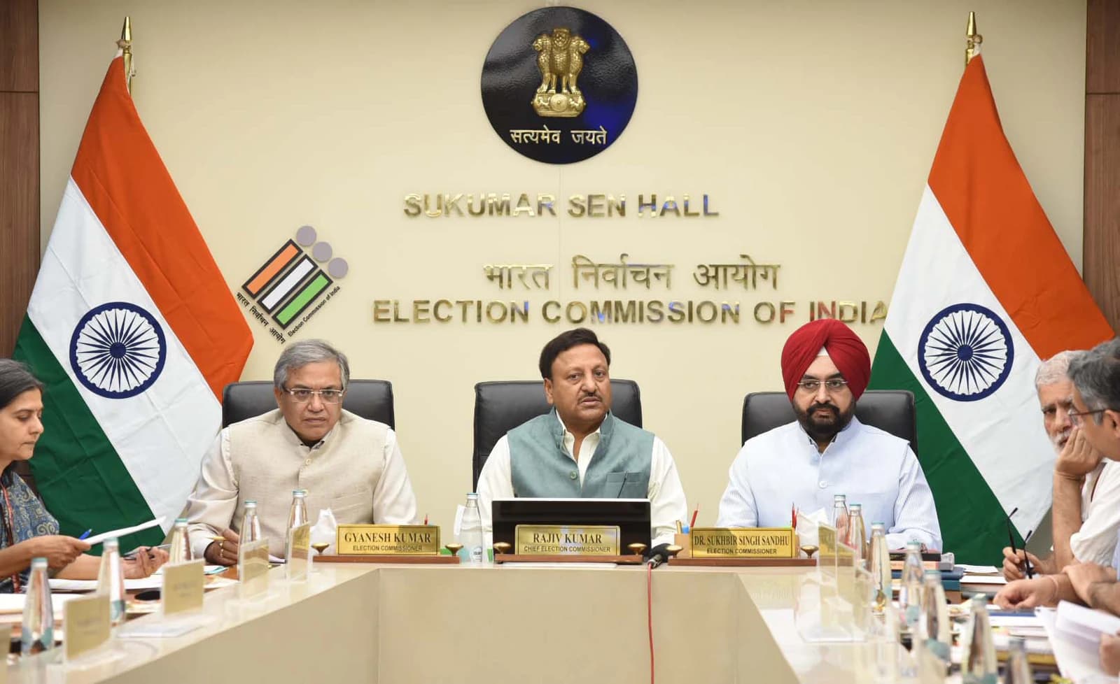 Rajiv Kumar, Chief Election Commissioner of India, seated at a conference table with two other election commissioners.