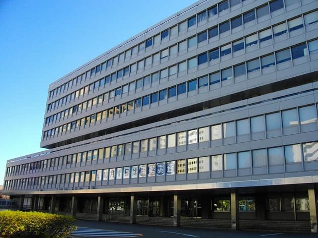 Statistics Bureau of Japan building exterior with rows of windows and a clear blue sky.