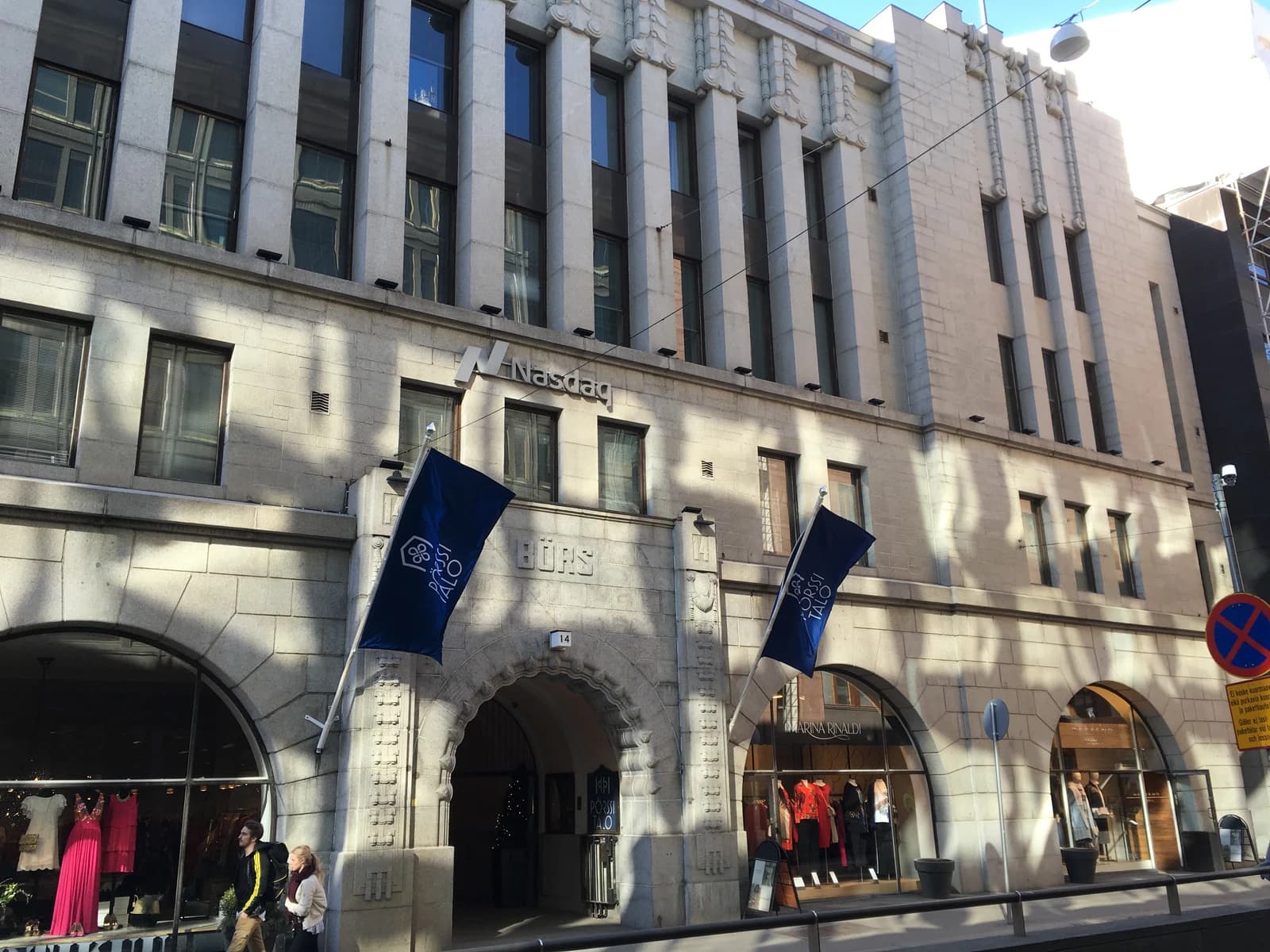 Exterior of the Nasdaq stock exchange building in Helsinki, Finland, on a sunny day.