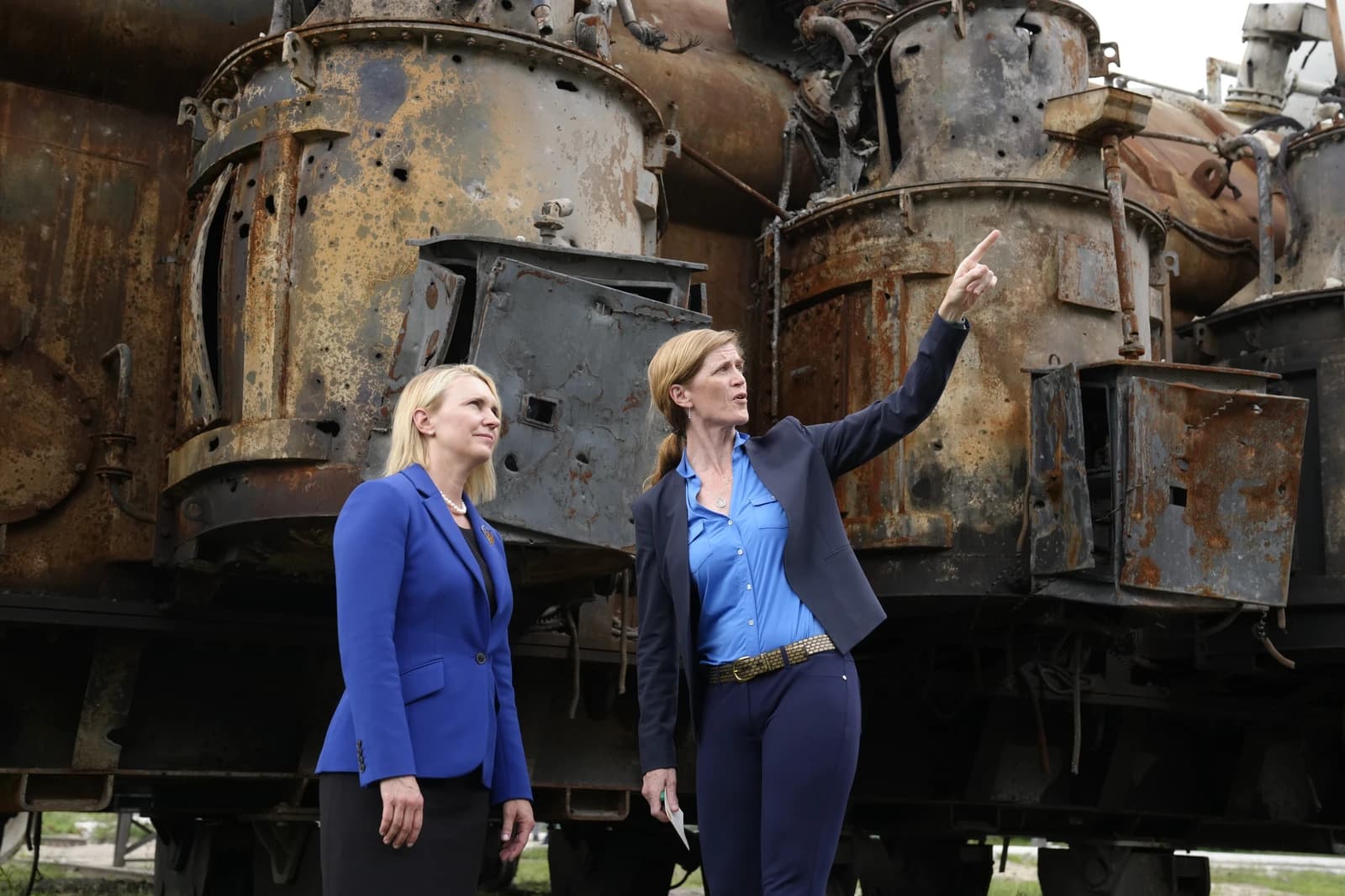 Administrator Samantha Power and another official observing damaged military equipment in Ukraine.