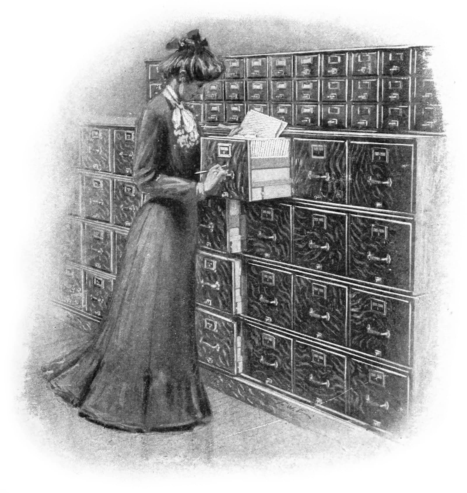 Woman organizes documents in a Macey vertical filing cabinet.