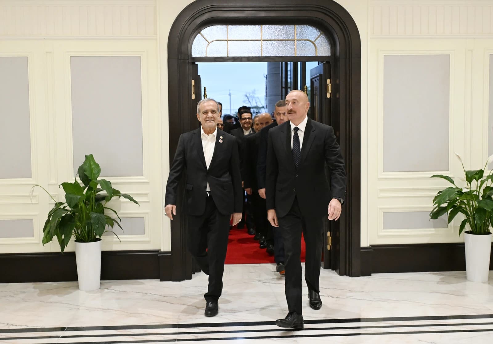 President Ilham Aliyev of Azerbaijan and President of Iran walking together through a doorway.