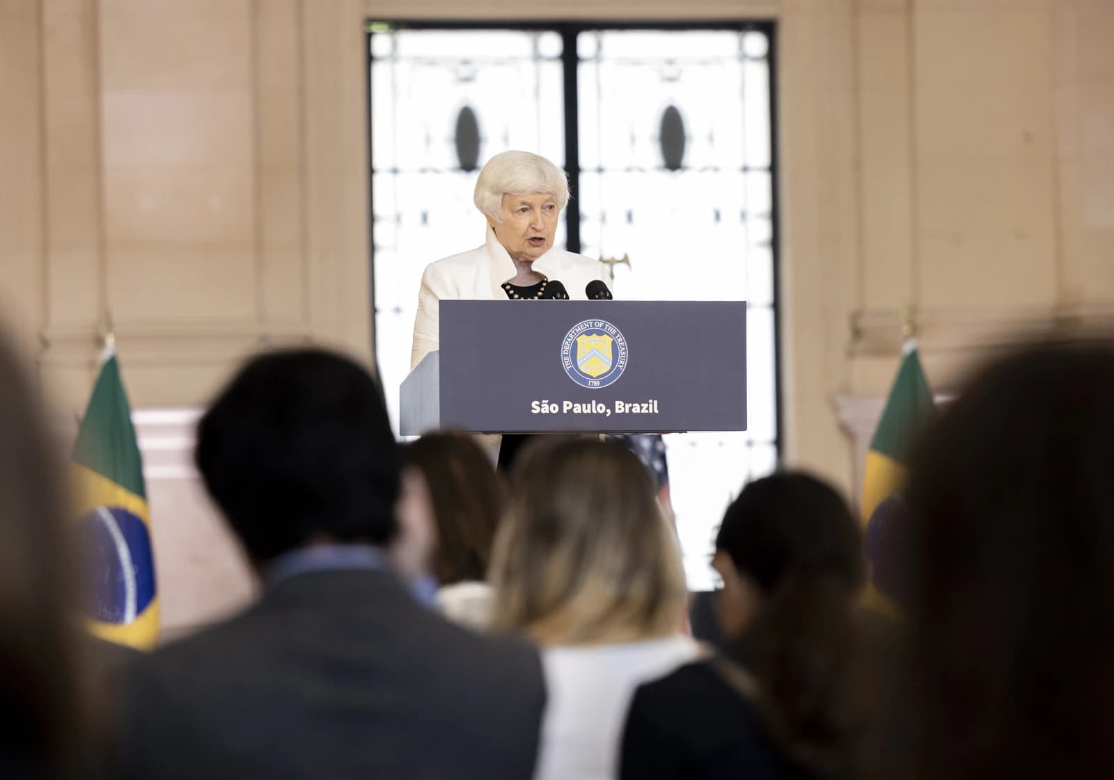 Janet Yellen, US Treasury Secretary, speaks at a podium in São Paulo, Brazil.