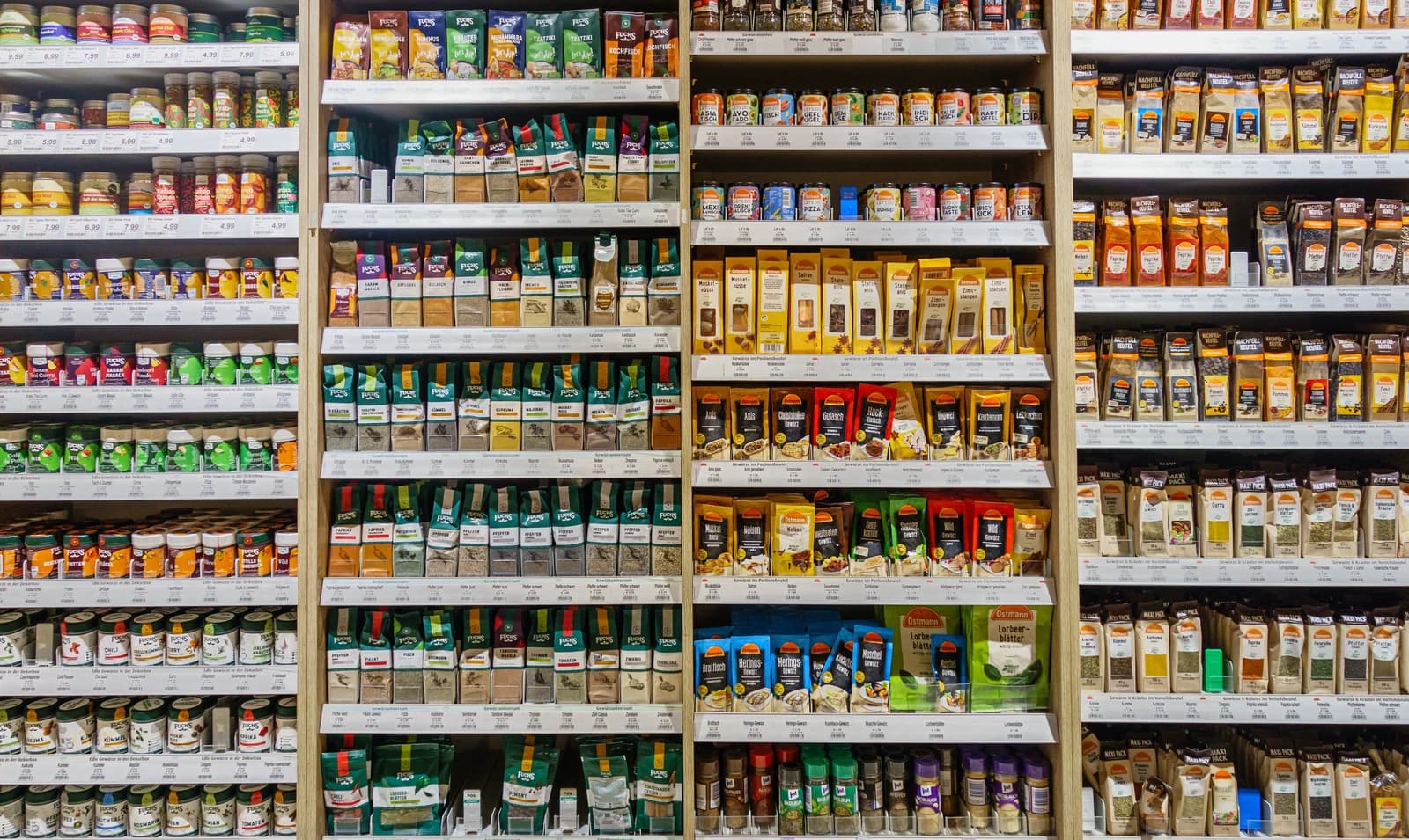 Grocery store shelves filled with various packaged spices and seasonings.