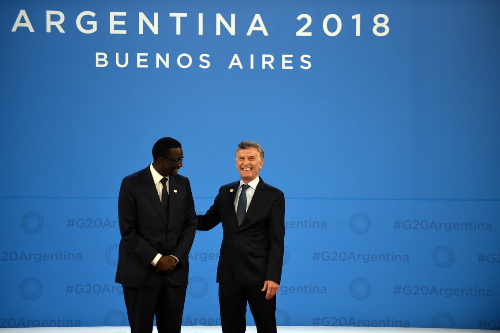 Amadou Ba, Senegal's Minister of Economy and Finance, stands with another man at an event.
