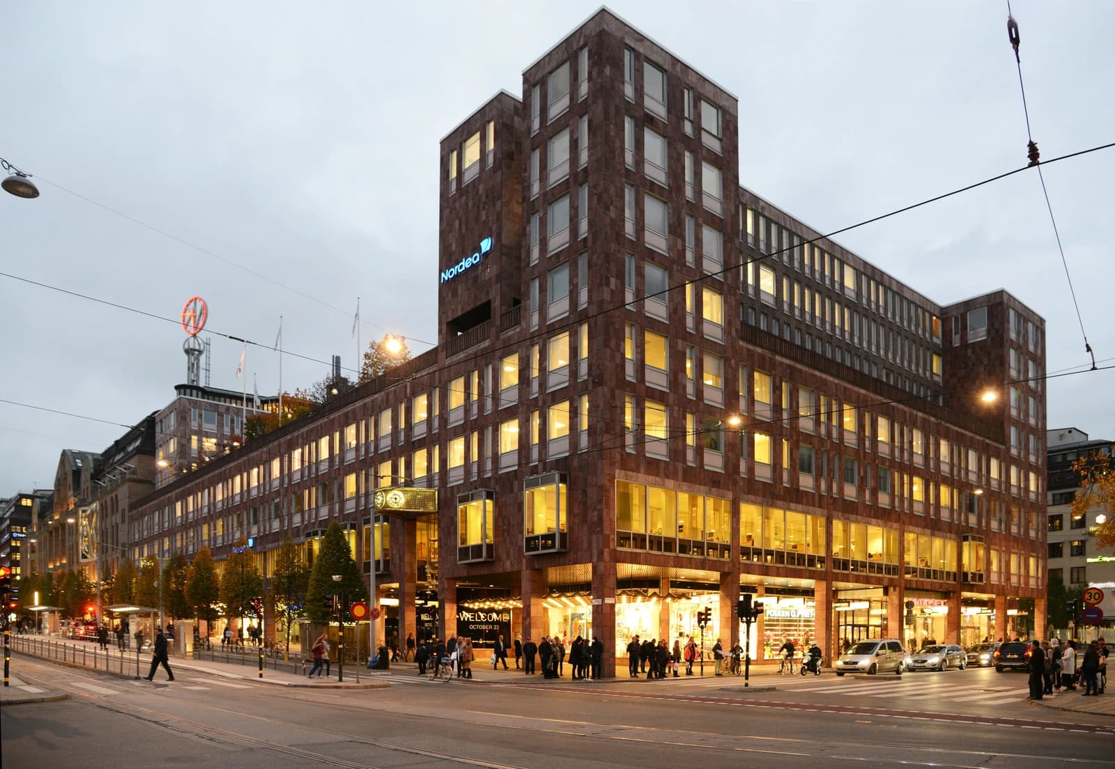 Exterior of the Nordea bank building in Stockholm, Sweden, with street traffic.