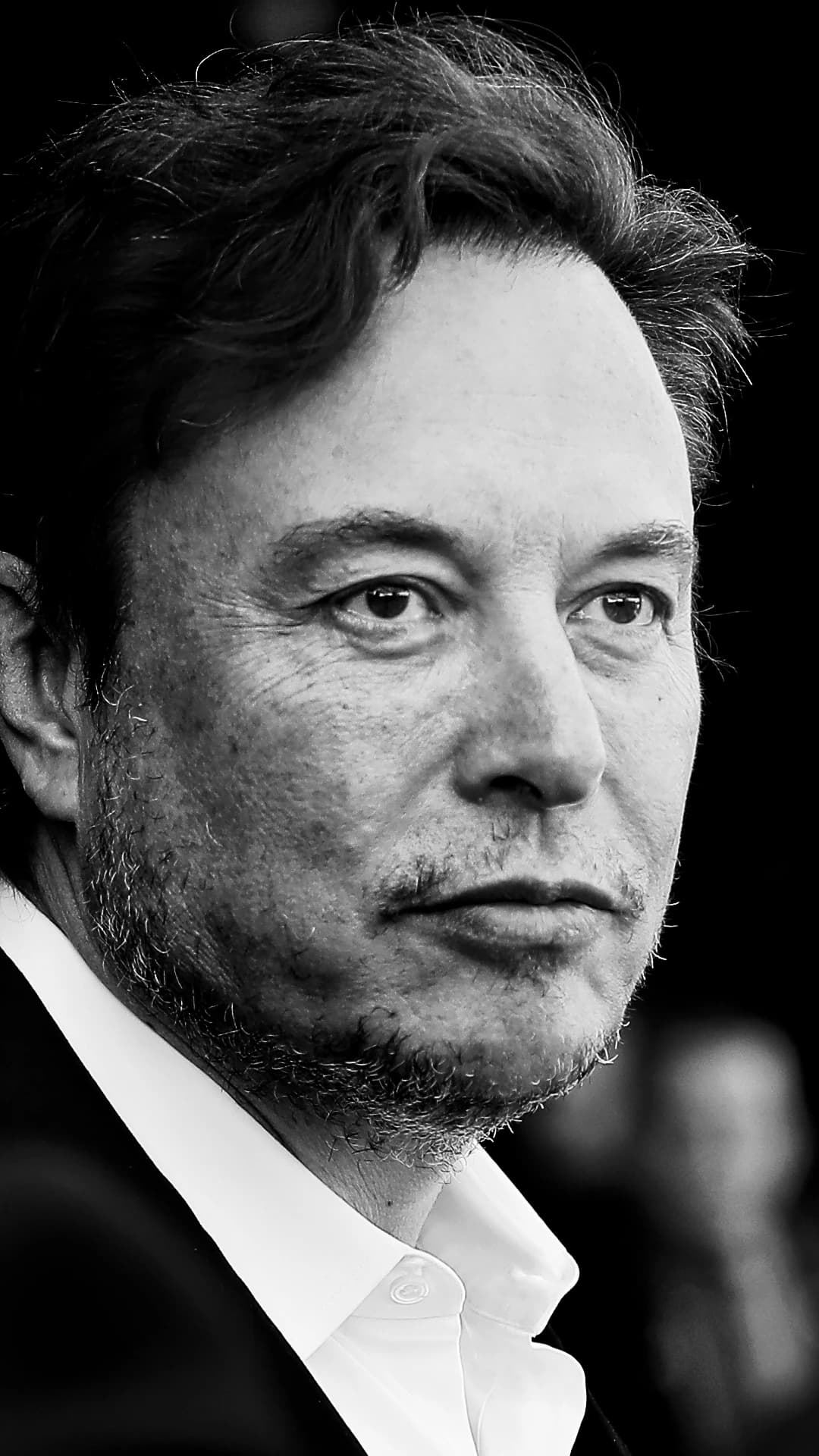 Elon Musk, CEO of SpaceX, looking toward the right side of the frame.