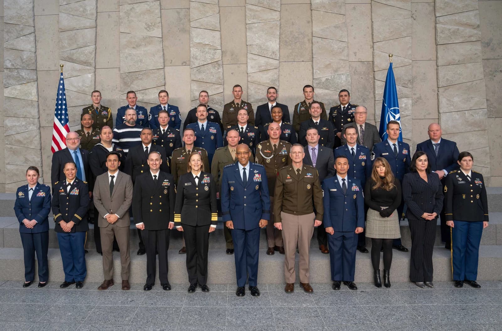 General CQ Brown Jr., Chairman of the Joint Chiefs of Staff, and Vice Admiral Shoshana Chatfield, U.S. Military Representative, stand with other military officials at NATO Headquarters.