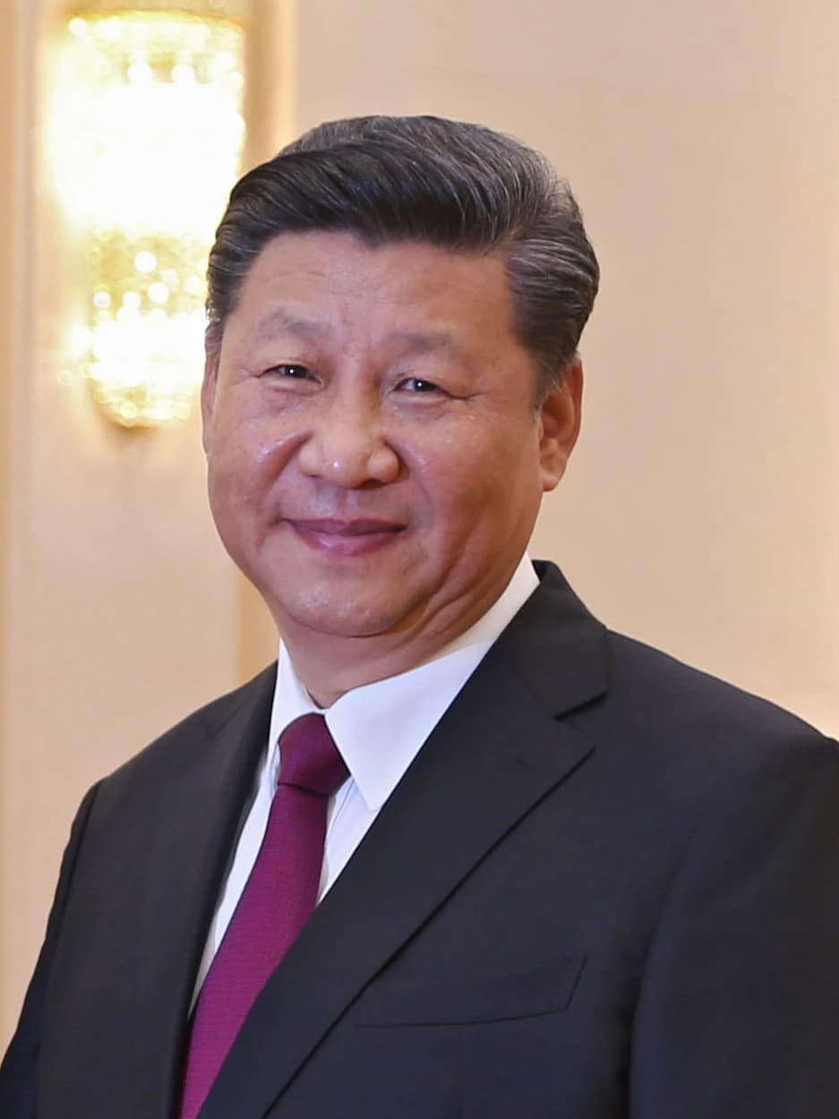 Xi Jinping, President of China, smiling for a portrait photograph.