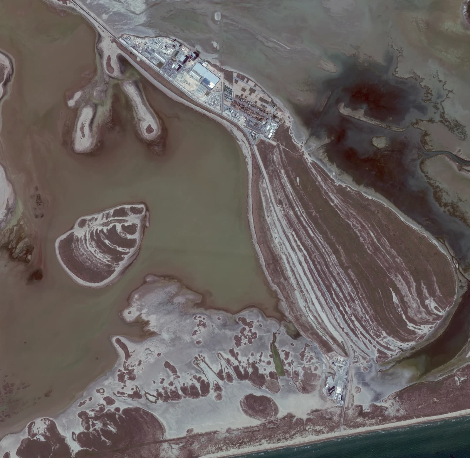 Aerial photograph of SpaceX's Starbase facility, with buildings and launch infrastructure visible.