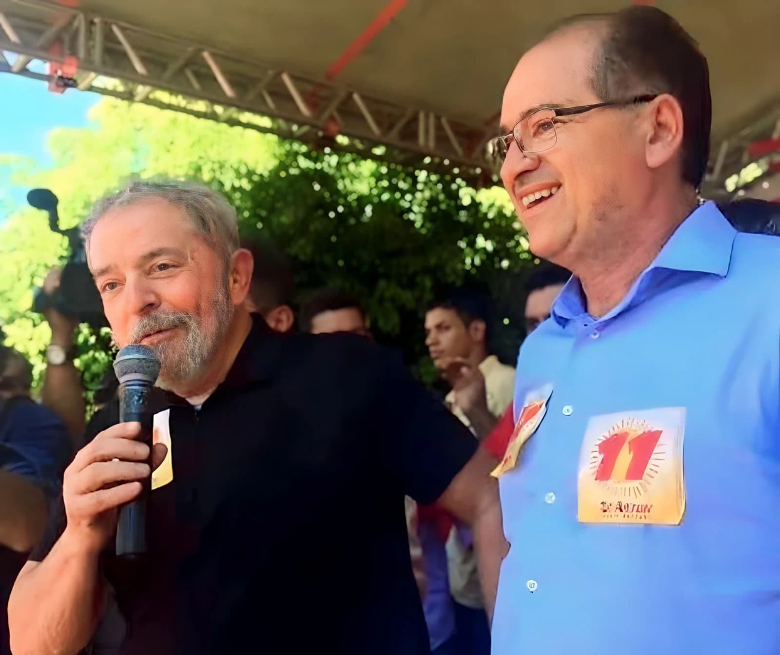 Luiz Inácio Lula da Silva speaking into a microphone at an outdoor event.