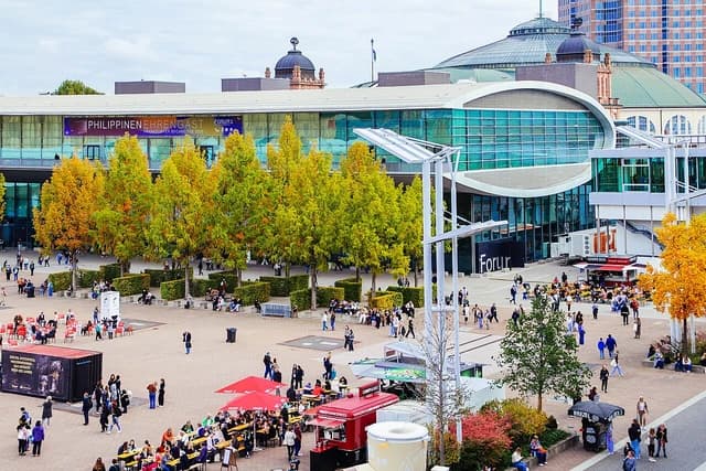 Aerial view of the Frankfurt Book Fair with people walking and buildings.