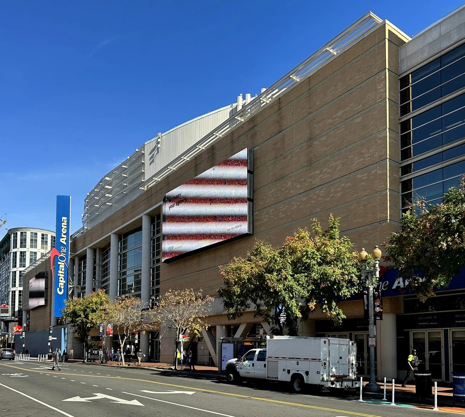 Exterior view of Capital One Arena in Washington, D.C. with a large screen.