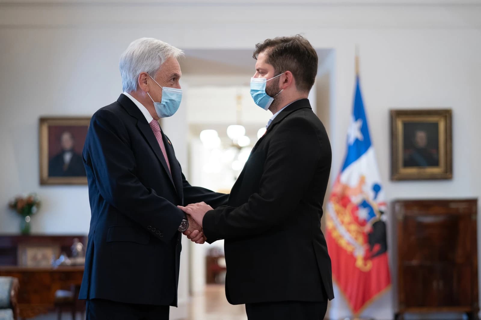 Sebastián Piñera, former President of Chile, shakes hands with President-elect Gabriel Boric.