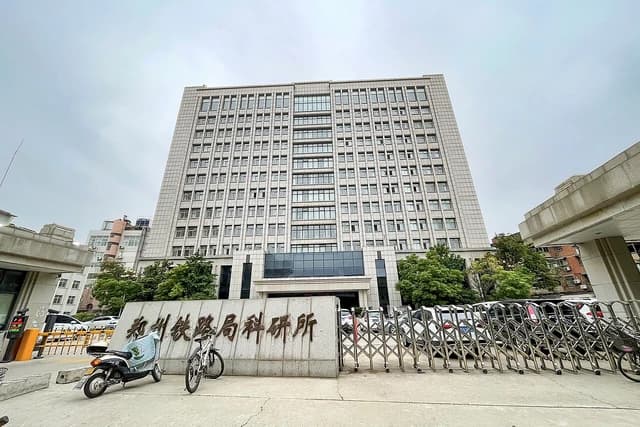 Exterior view of The Research Institute of Zhengzhou Railway Bureau building under a cloudy sky.