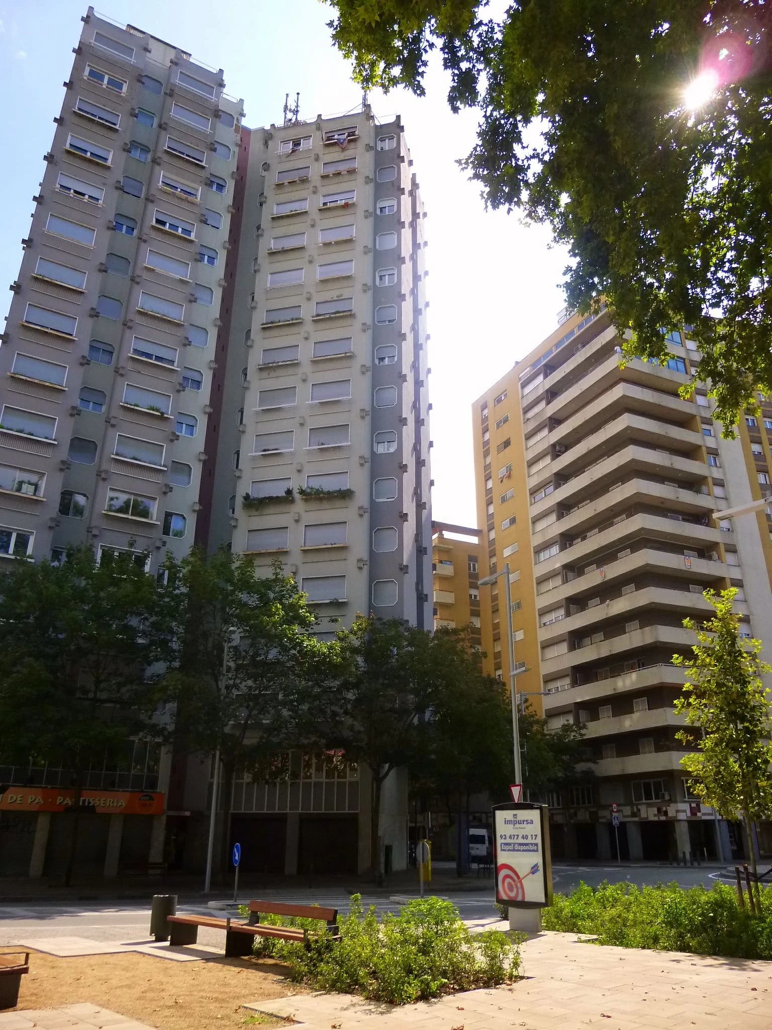 Tall residential buildings with many windows and balconies in a city.