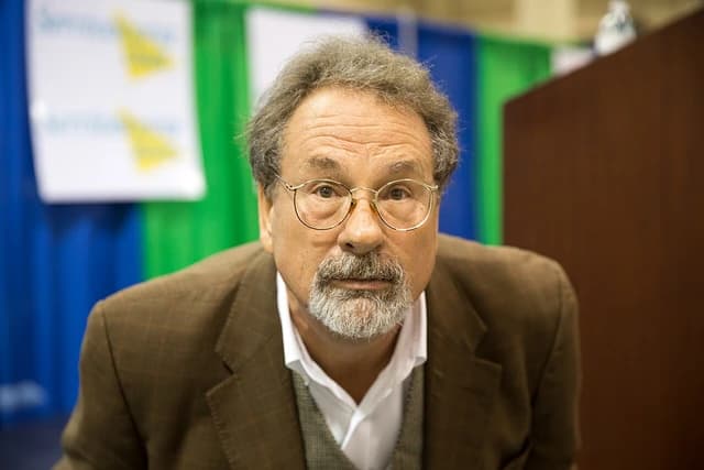 Mike Veeck, a business executive, looking directly at the camera at an expo.