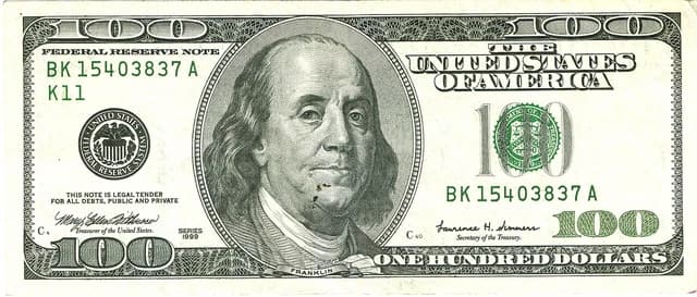A close-up view of a United States one hundred dollar bill.