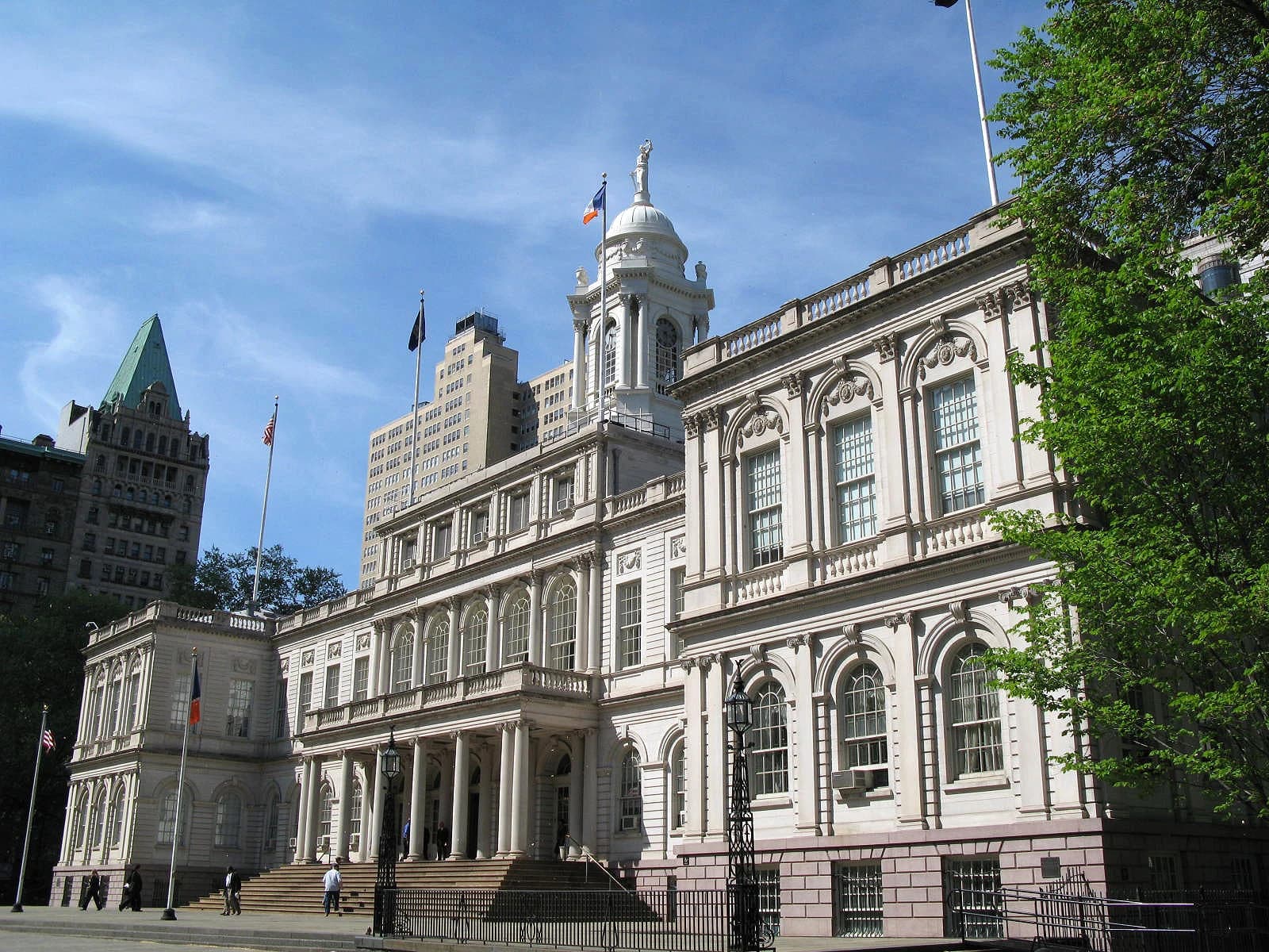 New York City Hall, an ornate building with columns and a dome.