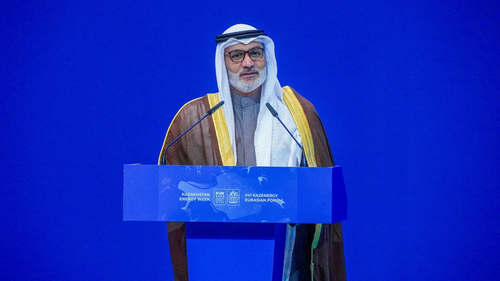 Haitham al-Ghais, OPEC Secretary General, speaking at a podium with microphones.